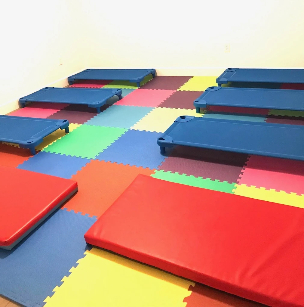 Our nap and rest space — cozy cots on soft play mats